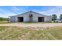 Large horse barn featuring two open doorways and well-maintained grounds at 6200 Adrian Pkwy., Conway, SC 29526