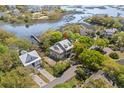 Breathtaking aerial view showcases a charming home surrounded by mature trees, offering waterfront access at 675 Wedgewood Dr., Murrells Inlet, SC 29576