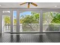 Relaxing screened-in porch features wood floors and panoramic views of the surrounding trees at 675 Wedgewood Dr., Murrells Inlet, SC 29576