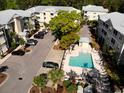 Aerial view of the community pool, lounge seating, and landscaping at a condominium complex at 70 Mingo Dr. # 3-E, Pawleys Island, SC 29585
