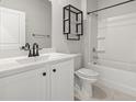Bright bathroom featuring a single sink vanity, stylish fixtures, and a shower-tub combination at 7005 Grant St., Little River, SC 29566