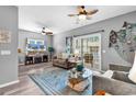 Comfortable living room with ample seating, ceiling fan and sliding glass doors to patio at 7207 Sweetwater Blvd. # 7207, Murrells Inlet, SC 29576