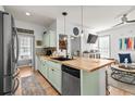 Bright kitchen with butcher block island, stainless steel appliances, and open layout at 77 Weatherboard Ct., Pawleys Island, SC 29585