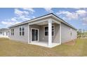 Covered back porch featuring white columns perfect for outdoor relaxation and overlooking the backyard at 882 Farmers Passage Loop, Loris, SC 29569