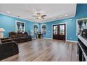 Spacious living room with wood floors, bright blue walls and large windows that enhance natural light at 968 Shipmaster Ave., Myrtle Beach, SC 29579