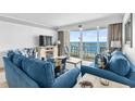 Cozy living room with ocean view balcony, comfortable seating, and stylish decor for relaxation and entertainment at 1012 N Waccamaw Dr. # 507, Murrells Inlet, SC 29576