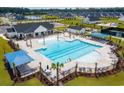 Aerial view showcasing a resort-style pool, comfortable lounging areas, clubhouse, and a surrounding residential area at 1091 Laconic Dr., Myrtle Beach, SC 29588