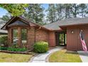Inviting brick home featuring a charming walkway and well-maintained landscaping at 114 Laurelwood Ln., Conway, SC 29526