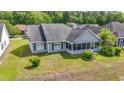 A peaceful screened-in porch and well-maintained backyard of a single Gathering house at 121 Ashworth Dr., Little River, SC 29566