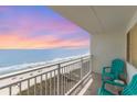 Balcony with ocean views and teal chairs, perfect for relaxing and enjoying the beautiful scenery at 1709 S Ocean Blvd. # 608, North Myrtle Beach, SC 29582