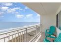 Balcony with ocean views and teal chairs, perfect for relaxing and enjoying the beautiful scenery at 1709 S Ocean Blvd. # 608, North Myrtle Beach, SC 29582