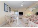 Cozy condo living room with dining area, ceiling fan, and water views at 1709 S Ocean Blvd. # 608, North Myrtle Beach, SC 29582
