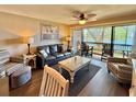 Comfortable living room with wood floors and sliding glass doors to the balcony at 180 Rothbury Circle # 116, Myrtle Beach, SC 29572
