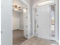Inviting foyer with tile flooring, an arched door, and views into the adjacent room at 197 Northside Dr., Little River, SC 29566