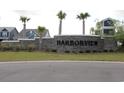 Stone entrance sign for the Harborview community, framed by palm trees and lush landscaping at 2005 Tiller Ct., Myrtle Beach, SC 29579