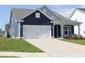 Exterior showcasing the side of a charming home with a two-car garage and manicured lawn at 2005 Tiller Ct., Myrtle Beach, SC 29579