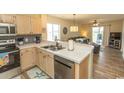 Bright kitchen with stainless steel appliances and breakfast bar overlooking the living area offers seamless entertaining at 201 Landing Rd. # D, North Myrtle Beach, SC 29582