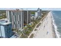 Aerial view of condo buildings and oceanfront property featuring a swimming pool and sandy beach at 2701 N Ocean Blvd. # 561/563, Myrtle Beach, SC 29577
