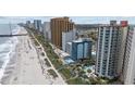 Gorgeous aerial view featuring sandy beach, ocean, palm trees, swimming pool, and several buildings at 2701 N Ocean Blvd. # 561/563, Myrtle Beach, SC 29577