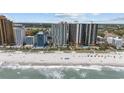Beautiful beach view of buildings and ocean on a sunny day with clear skies and crashing waves at 2701 N Ocean Blvd. # 561/563, Myrtle Beach, SC 29577