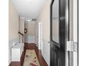 Inviting hallway with wood floors, white wainscoting, and a decorative rug at 320 Saint Catherine Bay Ct., Surfside Beach, SC 29575