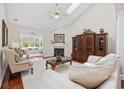 Cozy living room with vaulted ceilings, skylight, and fireplace at 3224 Hermitage Dr., Little River, SC 29566