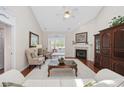 Bright living room with vaulted ceiling, fireplace, and hardwood floors at 3224 Hermitage Dr., Little River, SC 29566
