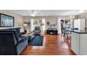 Stylish living room featuring hardwood floors, an entertainment center, and a dining area at 333 14Th Ave. S, Surfside Beach, SC 29575
