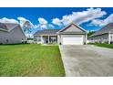 Well-maintained home with a two-car garage, complemented by a green lawn and clear driveway at 377 Copperwood Loop, Conway, SC 29526
