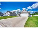 Well-maintained home boasts a long driveway, attached garage, and lush lawn, nestled in a quiet neighborhood at 377 Copperwood Loop, Conway, SC 29526