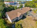Aerial shot of house highlighting its roof and proximity to shopping area at 415 42Nd Ave. N, Myrtle Beach, SC 29577