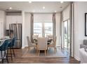 Dining room area filled with lots of natural light, set with a table and 6 chairs at 4369 Falls Oaks St., Myrtle Beach, SC 29579
