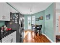 Bright kitchen nook featuring a table, hardwood flooring, and a view of the property's outdoor area at 4755 Lightkeepers Way # 15-E, Little River, SC 29566