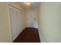 Hallway with wood floor and a white door plus a closet with louvered doors at 5001 Little River Rd. # E-410, Myrtle Beach, SC 29577