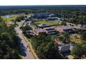Aerial shot of the neighborhood with a baseball field and green trees in the background at 5002 Riverton Ct, Myrtle Beach, SC 29579