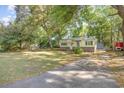 View of a single-story home with a well-maintained lawn and a driveway at 508 Pearl St., Conway, SC 29527
