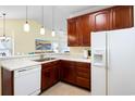 Bright eat-in kitchen featuring tile flooring, marble countertops, and stainless steel faucet at 5876 Longwood Dr. # 201, Murrells Inlet, SC 29576