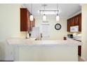 Eat-in kitchen features pendant lights, marble countertops, white appliances, and tile floors at 5876 Longwood Dr. # 201, Murrells Inlet, SC 29576