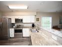 Bright kitchen features stainless steel appliances, light countertops, and white cabinets at 649 Tupelo Ln. # 13A, Longs, SC 29568