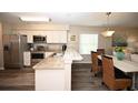 Open floor plan kitchen with stainless steel appliances, white cabinets, and dining area at 649 Tupelo Ln. # 13A, Longs, SC 29568