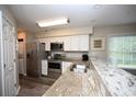 Bright kitchen features stainless steel appliances, light countertops, and white cabinets at 649 Tupelo Ln. # 13A, Longs, SC 29568