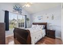 Bright bedroom with large window, vaulted ceiling, and coastal-themed decor at 812 Buteo Ct., Myrtle Beach, SC 29588