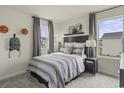 Cozy bedroom featuring plush carpet, and a comfortable bed beneath a bright window at 878 Cypress Preserve Circle, Longs, SC 29568