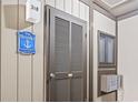 Hallway with utility access door and community signage at 9501 Shore Dr. # B-316, Myrtle Beach, SC 29572