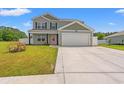 Inviting two-story home with a two-car garage, lush lawn, and well-maintained landscaping at 1008 Corn Husk Loop, Conway, SC 29527