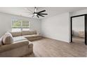 Cozy living room with a comfortable sectional sofa, a ceiling fan, and natural light at 1008 Corn Husk Loop, Conway, SC 29527