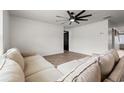 Comfortable living room featuring a sectional sofa, modern ceiling fan, and neutral decor at 1008 Corn Husk Loop, Conway, SC 29527