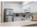 Bright kitchen featuring stainless steel refrigerator, white appliances and plenty of cabinet space at 102 Scotch Broom Dr. # 302-B, Little River, SC 29566