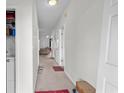 Hallway offers neutral tones and access to storage with an open door to a carpeted living area at 1058 Sea Mountain Hwy. # 5-301, North Myrtle Beach, SC 29582