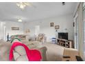 Living room with plush sofa, a ceiling fan, and a sliding glass door for natural light at 1058 Sea Mountain Hwy. # 5-301, North Myrtle Beach, SC 29582